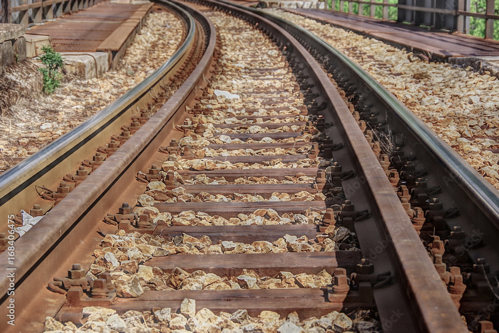 Close up view of railway track leading to the distance, turning left. HDR technique. Close up view of railway track leading to the distance, turning left. HDR technique.