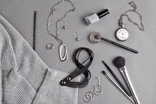 Flat lay with female accessories in gray shades