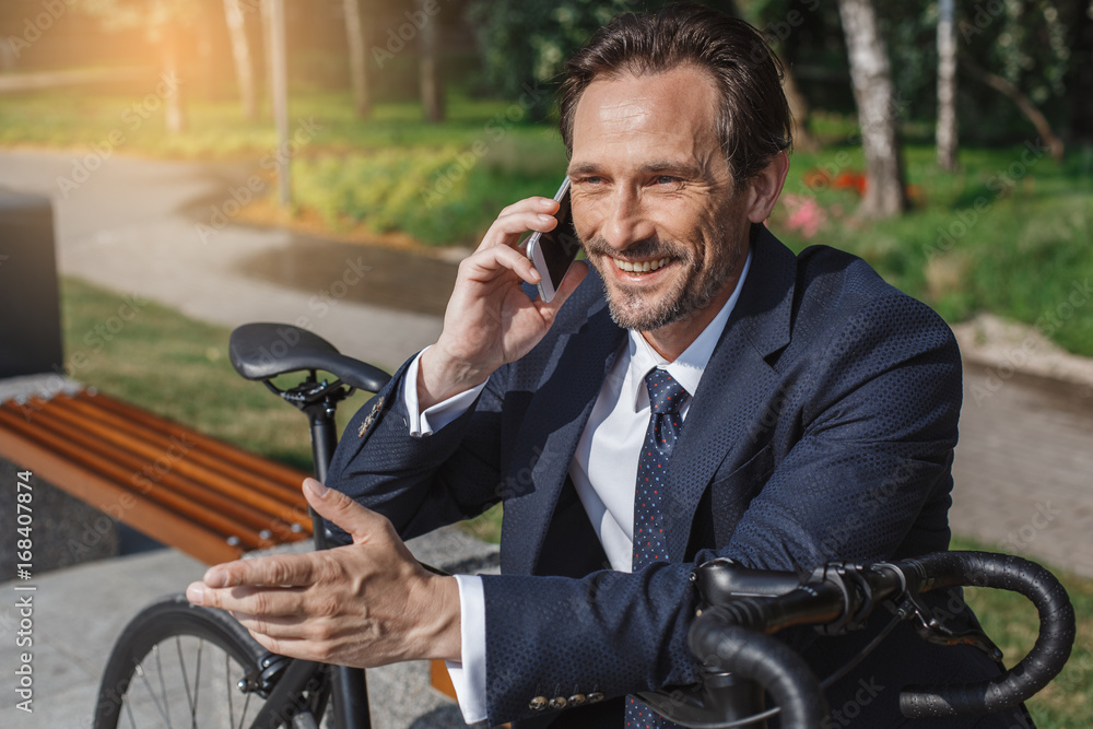 Senior business man with a bicycle outdoors