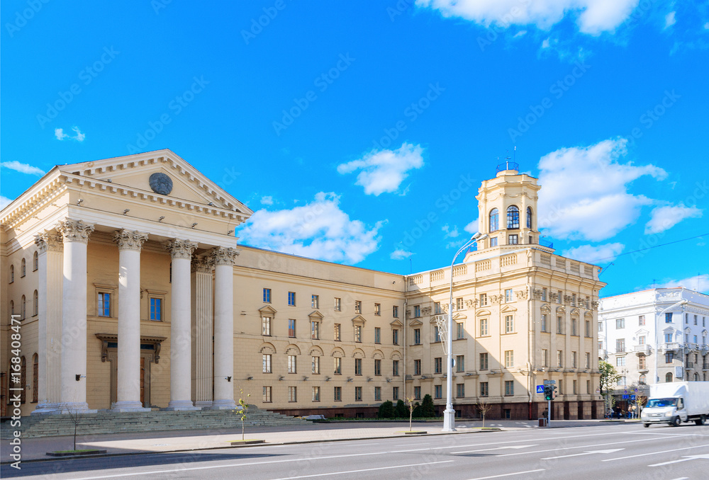 Central building kgb in Minsk, Belarus. Classical facade with columns. Blue sky with clouds. City landscape.