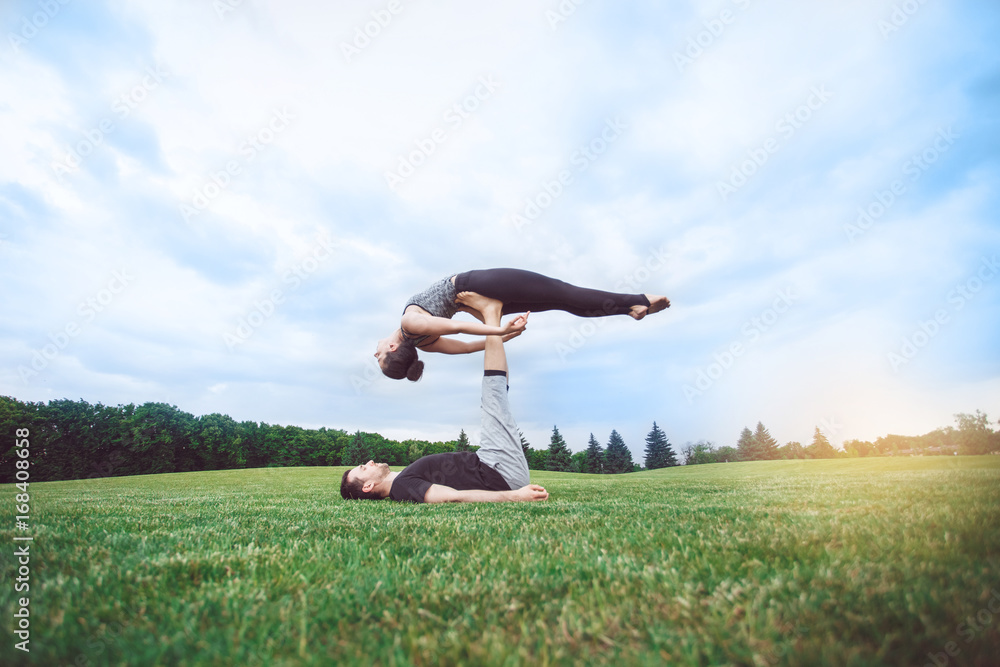People practice acro yoga outdoors healthy lifestyle People practice acro yoga outdoors healthy lifestyle