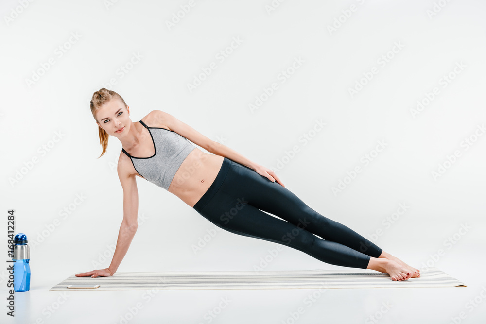 Girl doing side plank exercise Girl doing side plank exercise