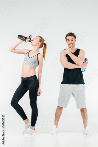 Fototapeta Naklejka Na Ścianę i Meble -  couple with fitness shakers