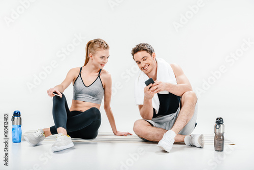 couple looking at phone after workout