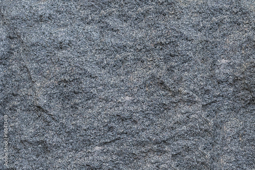 Texture gray granite rough untreated natural stone with white impregnations background natural pattern