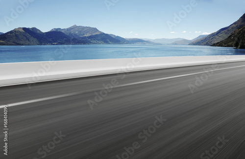 Asphalt road with Lake background