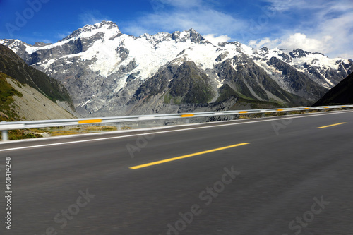 Asphalt road with snow mountain background