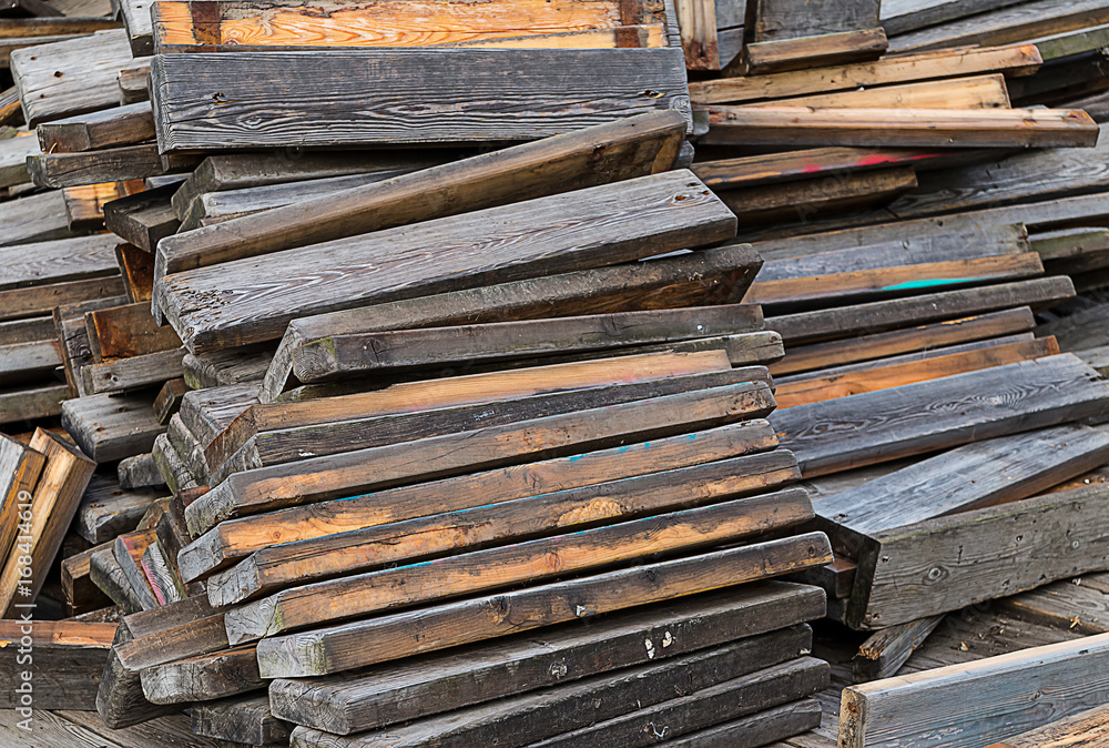 Stack of reclining old brown gray boards repair restoration building background Stack of reclining old brown gray boards repair restoration building background
