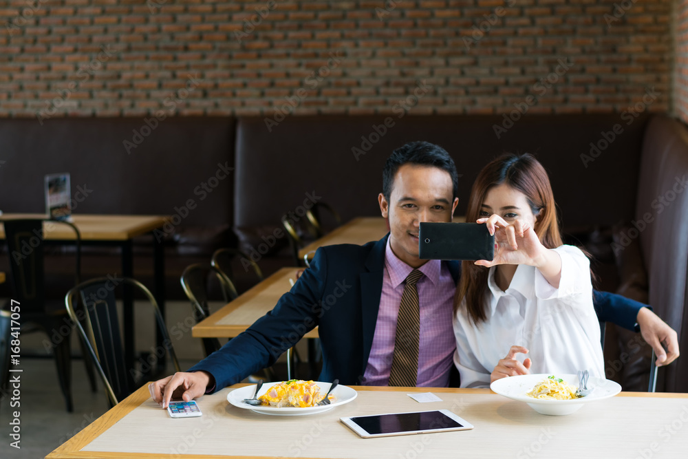 Couple photographed in a restaurant.