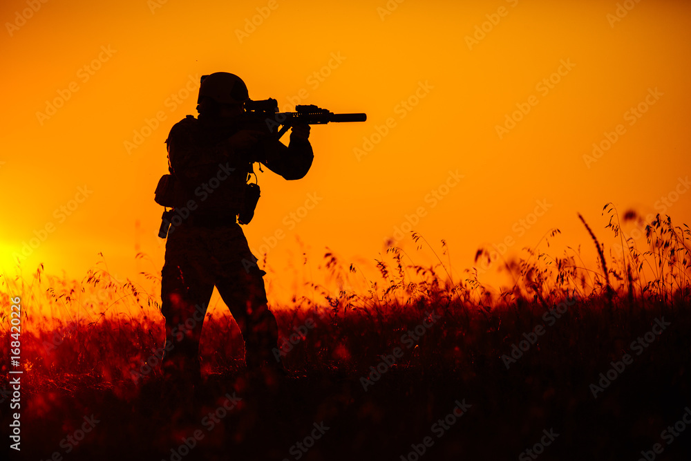 military soldier with weapons at sunset. shot, holding gun, colorful sky. military concept. military soldier with weapons at sunset. shot, holding gun, colorful sky. military concept.