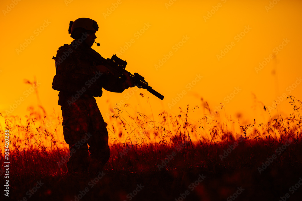 military soldier with weapons at sunset. shot, holding gun, colorful sky. military concept. military soldier with weapons at sunset. shot, holding gun, colorful sky. military concept.