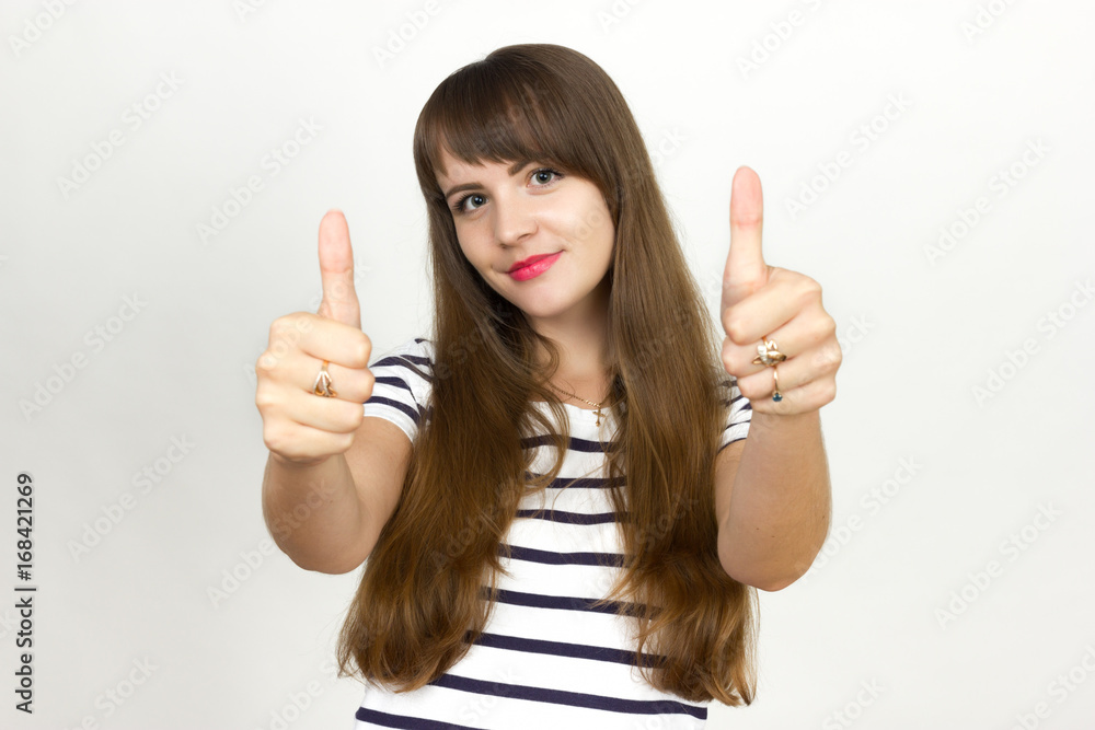 Portrait woman showing thumbs up standing over gray background Portrait woman showing thumbs up standing over gray background