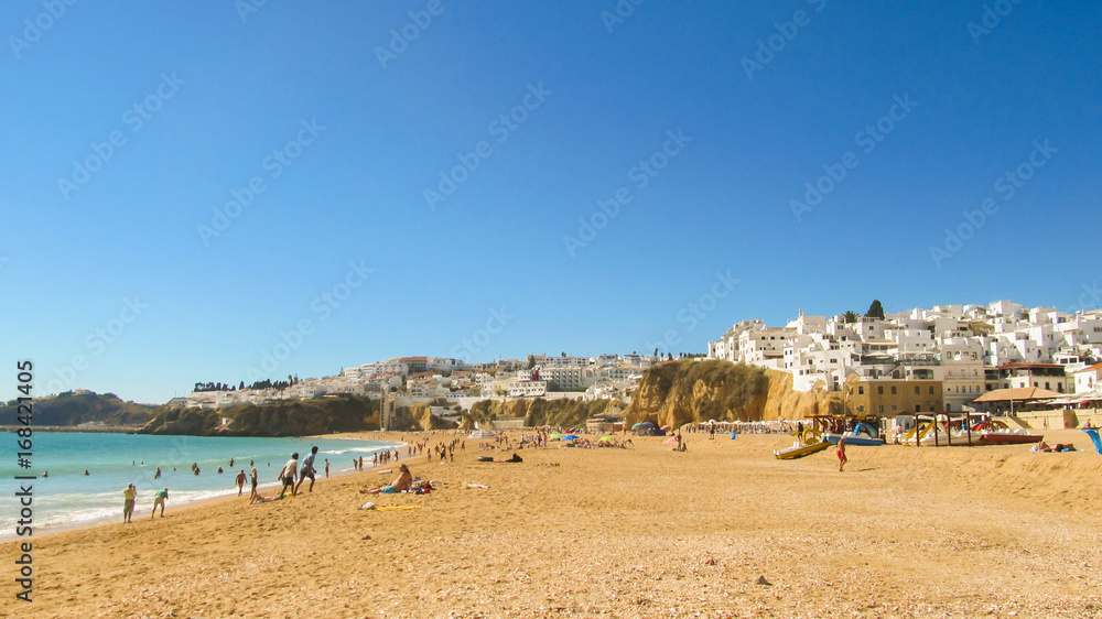 Albufeira, Portugal - Circa October 2013: Tourists enjoying the beach in Albufeira (Algarve region, Portugal)