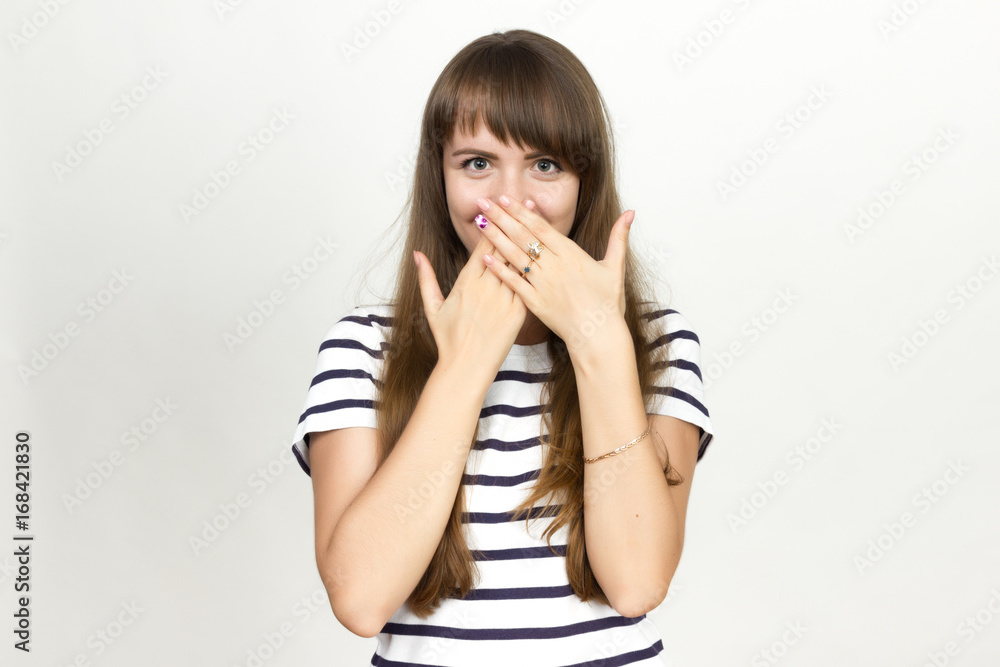 Portrait of a pretty woman covering her mouth Portrait of a pretty woman covering her mouth
