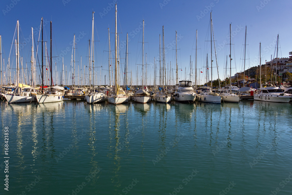 Sailing boats anchored in marina in a sunny day