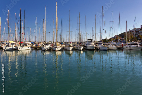Sailing boats anchored in marina in a sunny day