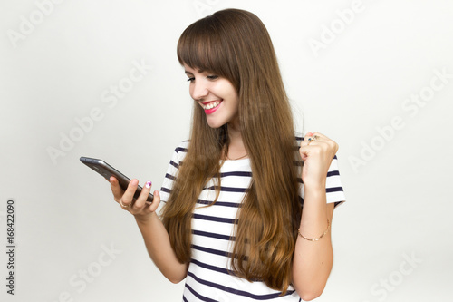  woman with mobile phone celebrating victory