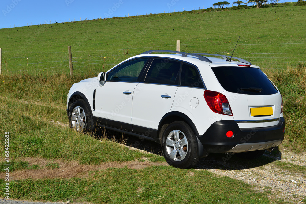 A white SUV driving off road in Sussex England