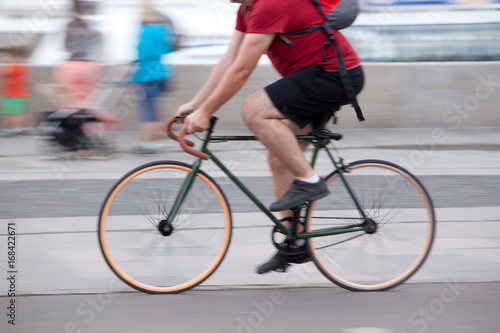 The man is riding a bicycle