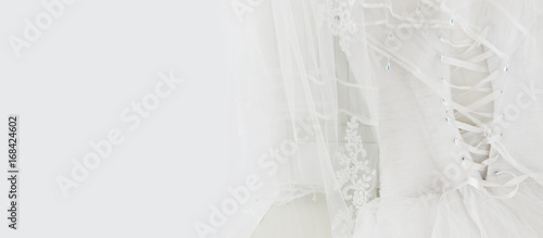 Beautiful white wedding dress and veil on chair