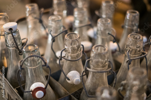 old empty bottles closeup - bottlenecks of vintage soda bottles in box