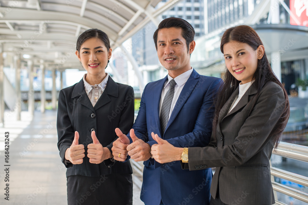 business man and business woman smile and show thumb up two hand at the city, successful concept business man and business woman smile and show thumb up two hand at the city, successful concept