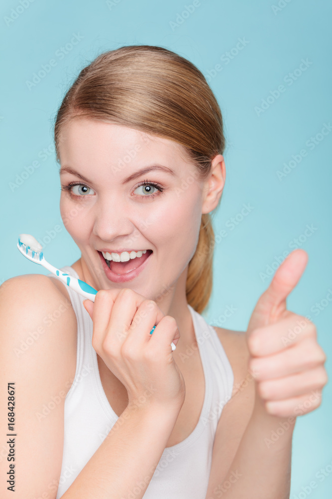 woman holds toothbrush with toothpaste cleaning teeth woman holds toothbrush with toothpaste cleaning teeth