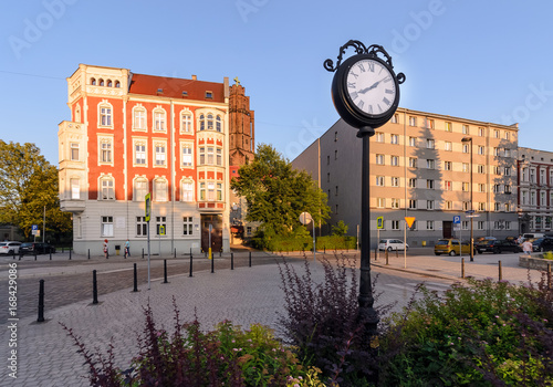 Town clock in central part of Gliwice during sunset.