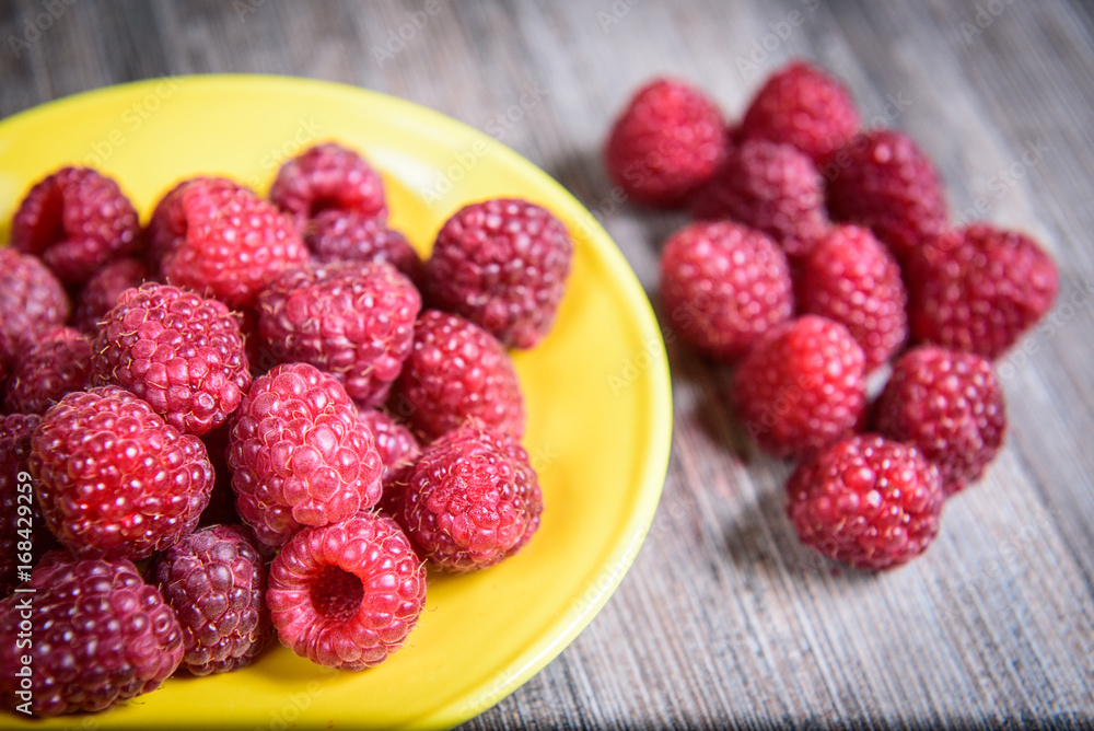 Healthy raspberry fresh organic fruit on a wooden table in vintage style Healthy raspberry fresh organic fruit on a wooden table in vintage style