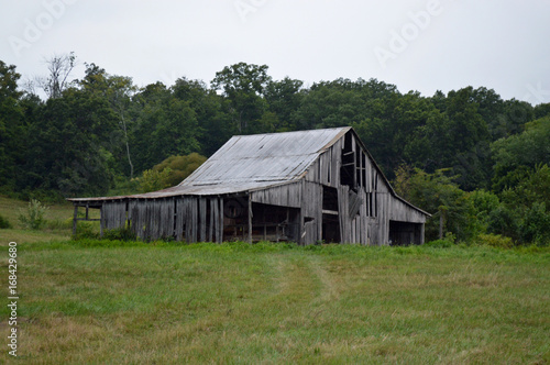Old rundown barn in a field on a farm