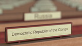 Democratic Republic of the Congo name sign among different countries plaques at international organization. 3D rendering