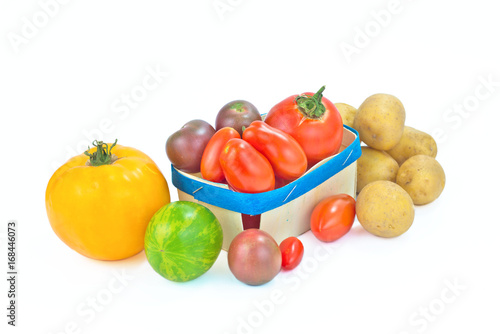 Assortment organic vegetable colorful tomatoes and potatoes isolated on white background