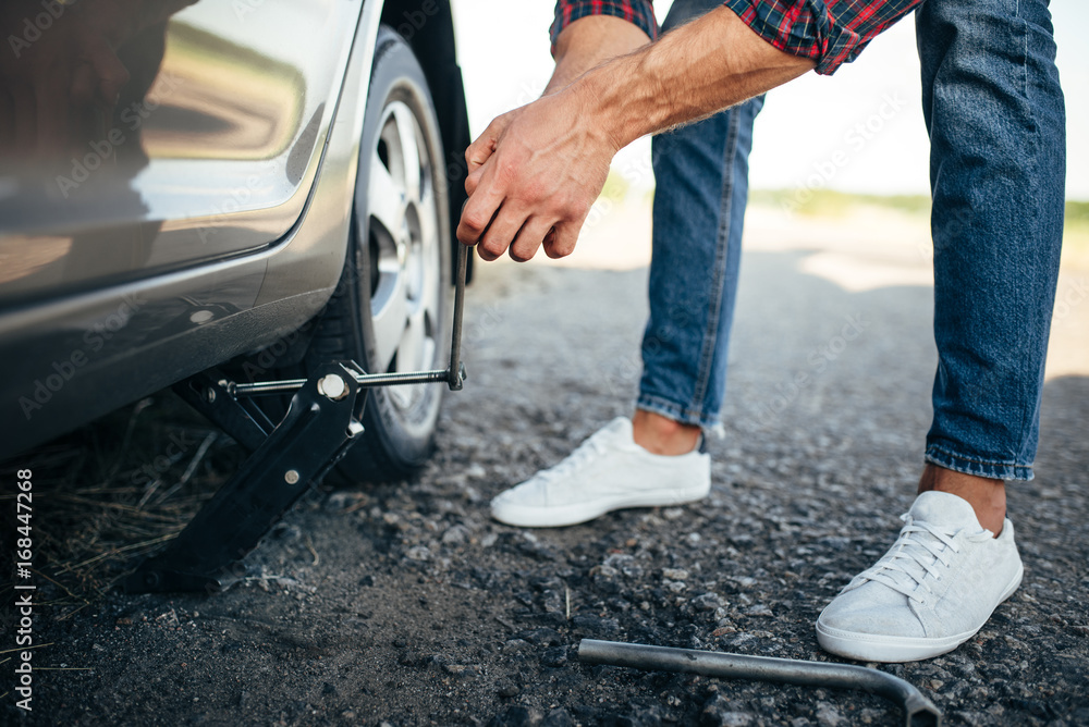 Man jack up broken car, wheel replacement Man jack up broken car, wheel replacement