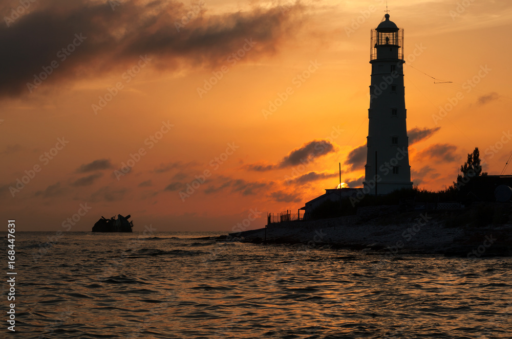 The lighthouse and the shipwreck: The lighthouse of Tarkhankut, Crimea at sunset