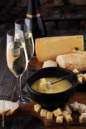 Canvas Print Gourmet Swiss fondue dinner on a winter evening with assorted ch