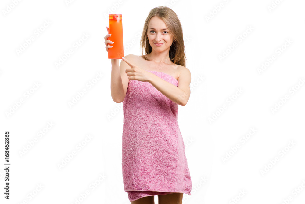 Beautiful young girl in towel with shampoo in hands Beautiful young girl in towel with shampoo in hands