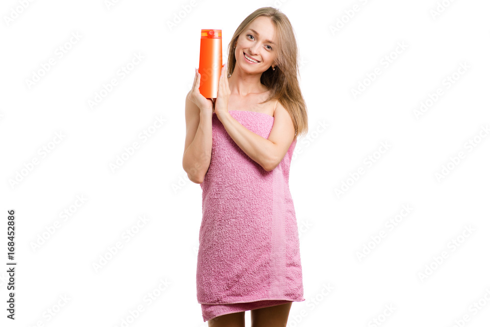 Beautiful young girl in towel with shampoo in hands Beautiful young girl in towel with shampoo in hands