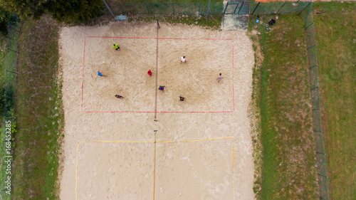 Aerial view of people playing beach volleyball. photo