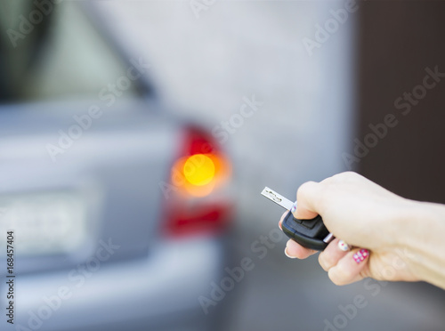 Hand locking the car with a key