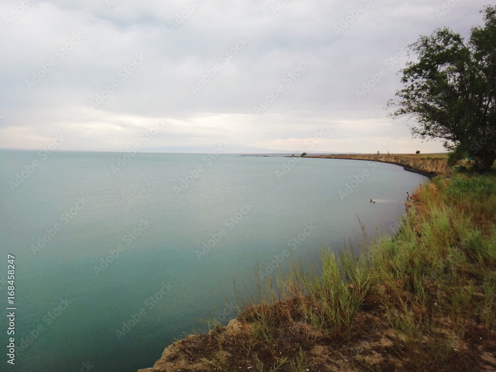 View of the lake in the steppe. Overcast. Evening.