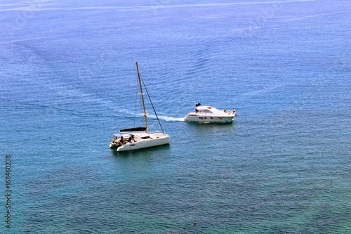 Two white sea yachts in the city harbor near the coast (Antalya, Turkey).