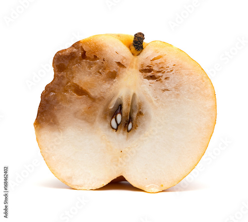 half of a cut out rotten pear on white background
