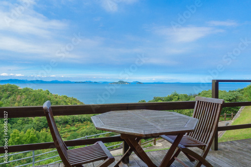 Terrace chair and table of a hotel and Setonaikai (Seto Inland) Sea under blue sky in Ehime, Japan
