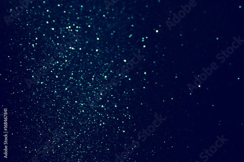 glitter vintage lights background. blue and black. de focused