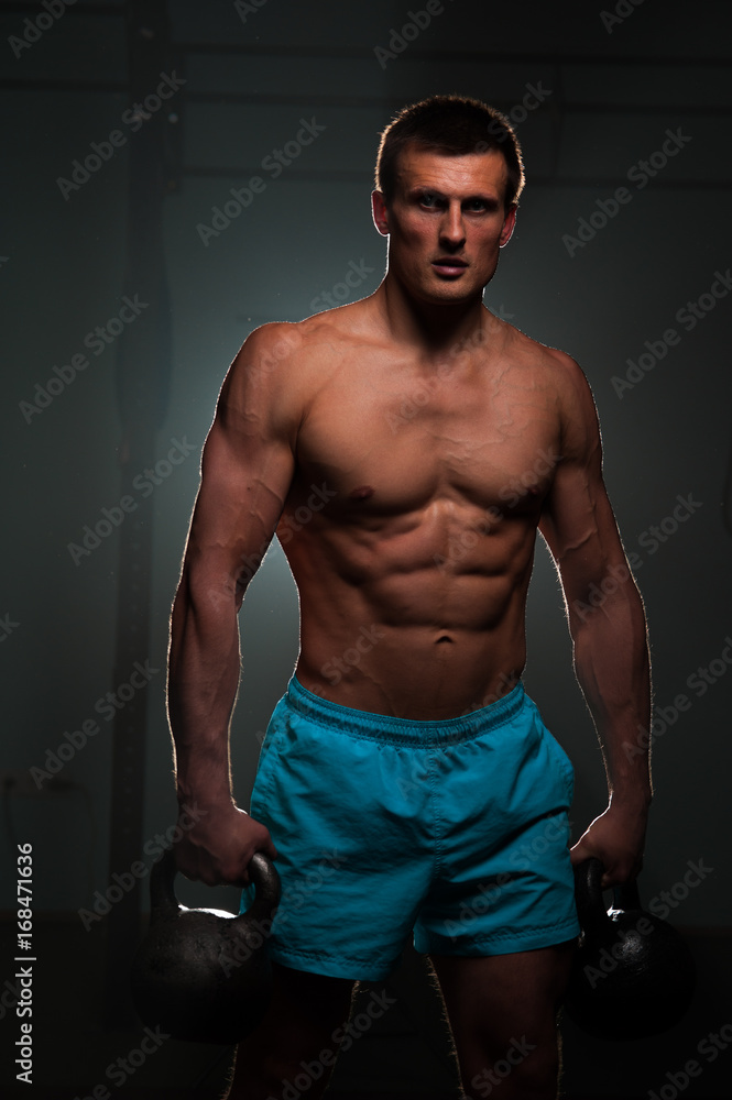 Fototapeta premium Fitness man with shirtless body posing in gym