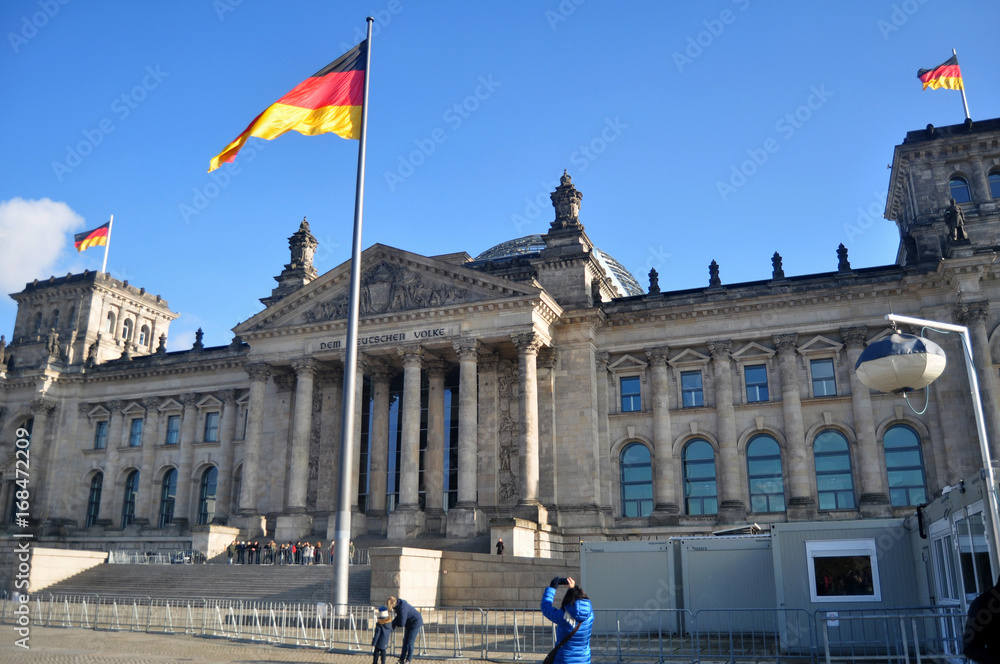 German people and foreigner travelers walk and posing for take photo at front of Reichstag building
