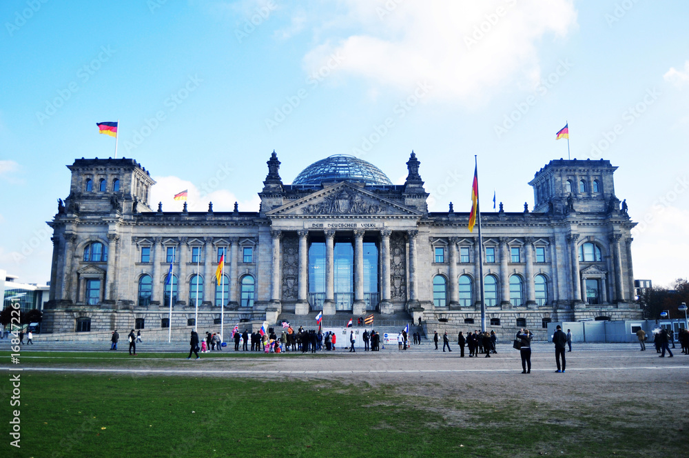German people and foreigner travelers walk and posing for take photo at front of Reichstag building