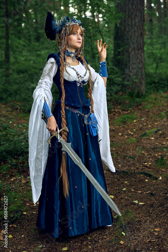 Valkyrie warrioress in magpie costume. Styling for the Scandinavian women's costume of the Viking Age. photo