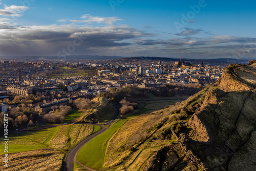 view across Edinburgh from Salisbury crags with rain clouds in the distance