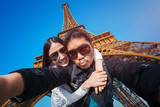 Young couple taking selfie with the Eiffel tower in Paris, France